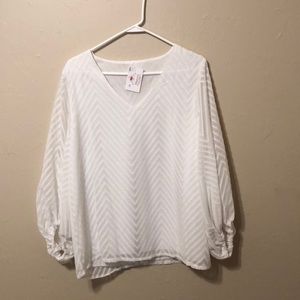 White blouse with chevron design.